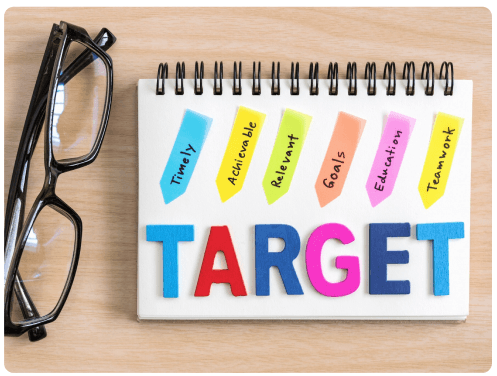 Notepad spelling TARGET next to a pair of glasses