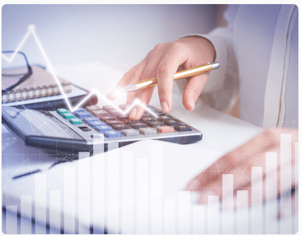 Accountant using a calculator with financial charts