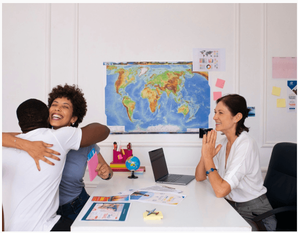 Team celebrating global expansion in front of a world map