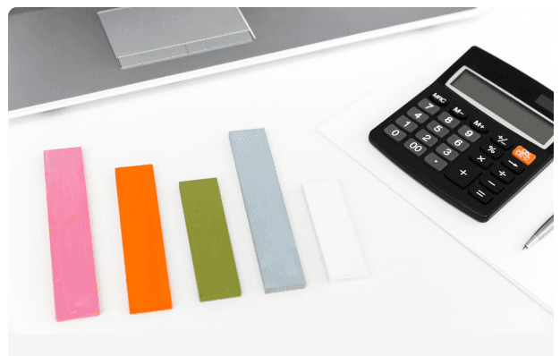 Bar chart made of colored blocks next to a calculator