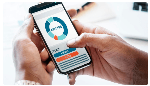 Hands holding a phone displaying a financial analysis app
