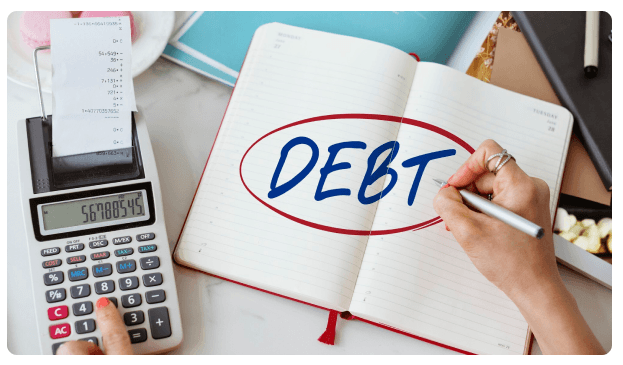 Notebook with the word 'Debt' circled beside a calculator and receipt