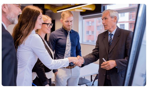 Group of colleagues shaking hands during a business meeting