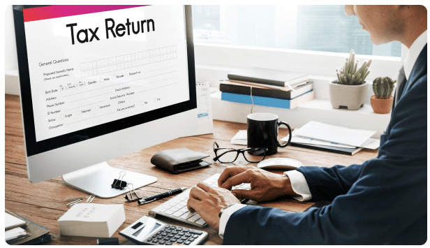 Businessperson filling out a tax return form on a computer