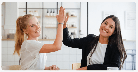 Two colleagues celebrating with a high five
