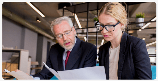 Two colleagues reviewing documents together
