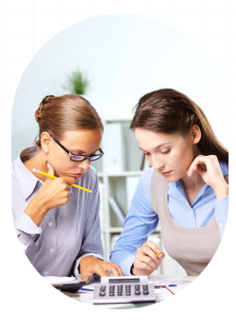 Two colleagues reviewing figures with a calculator
