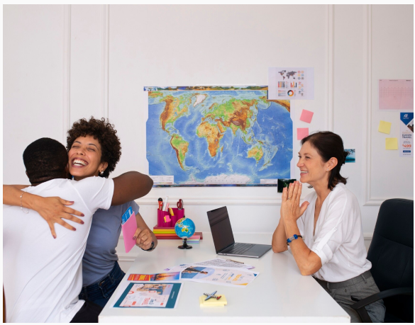 Team celebrating global expansion in front of a world map