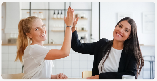 Two colleagues celebrating with a high five