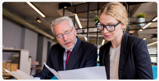 Two colleagues reviewing documents together